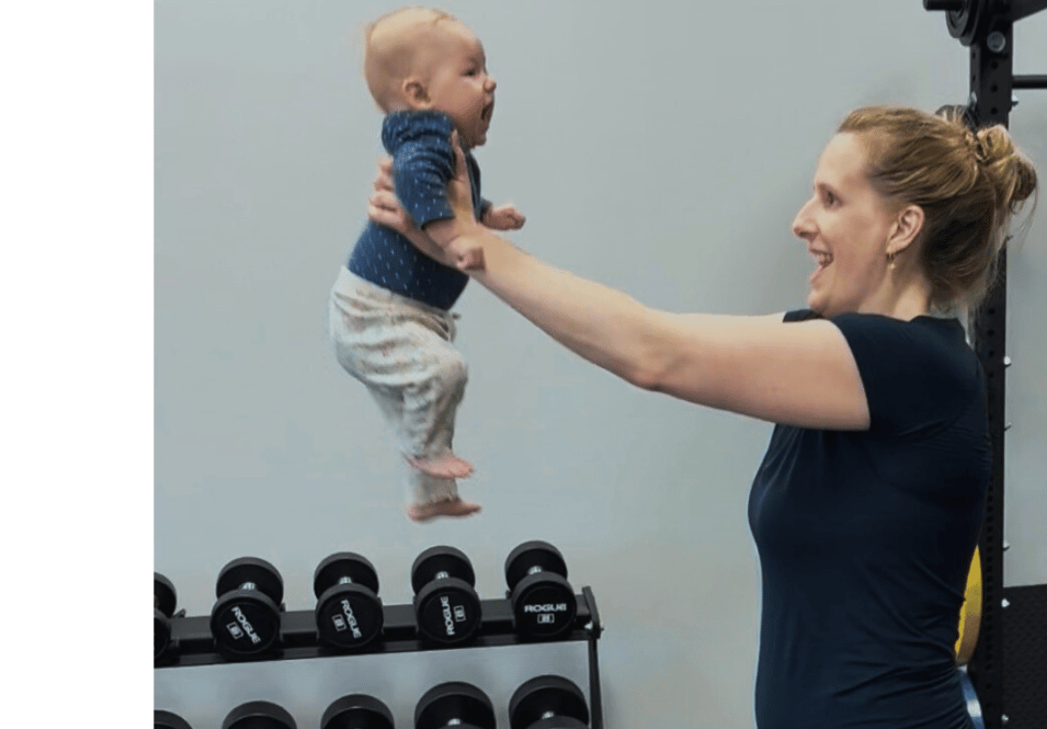 woman exercising with baby at the gym