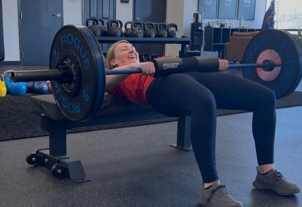 woman lifting weights at ROI Strength gym in Midlothian Virginia