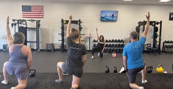 Personal Trainer Coaching Women Clients with Kettlebell Exercise at ROI Strength in Midlothian VA