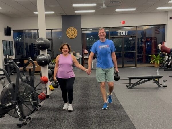 Couple Working Out Together for Strength Training at ROI Strength in Midlothian VA
